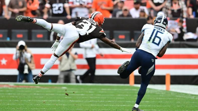 Sep 24, 2023; Cleveland, Ohio, USA; Cleveland Browns cornerback Denzel Ward (21) leaps to defend a pass to Tennessee Titans wide receiver Treylon Burks (16) during the second half at Cleveland Browns Stadium. Mandatory Credit: Ken Blaze-USA TODAY Sports