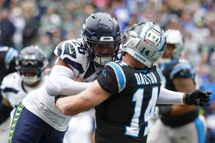 Sep 24, 2023; Seattle, Washington, USA; Seattle Seahawks safety Julian Love (20) hits Carolina Panthers quarterback Andy Dalton (14) following a pass attempt by Dalton during the first quarter at Lumen Field. Love was given a penalty on the play. Mandatory Credit: Joe Nicholson-USA TODAY Sports