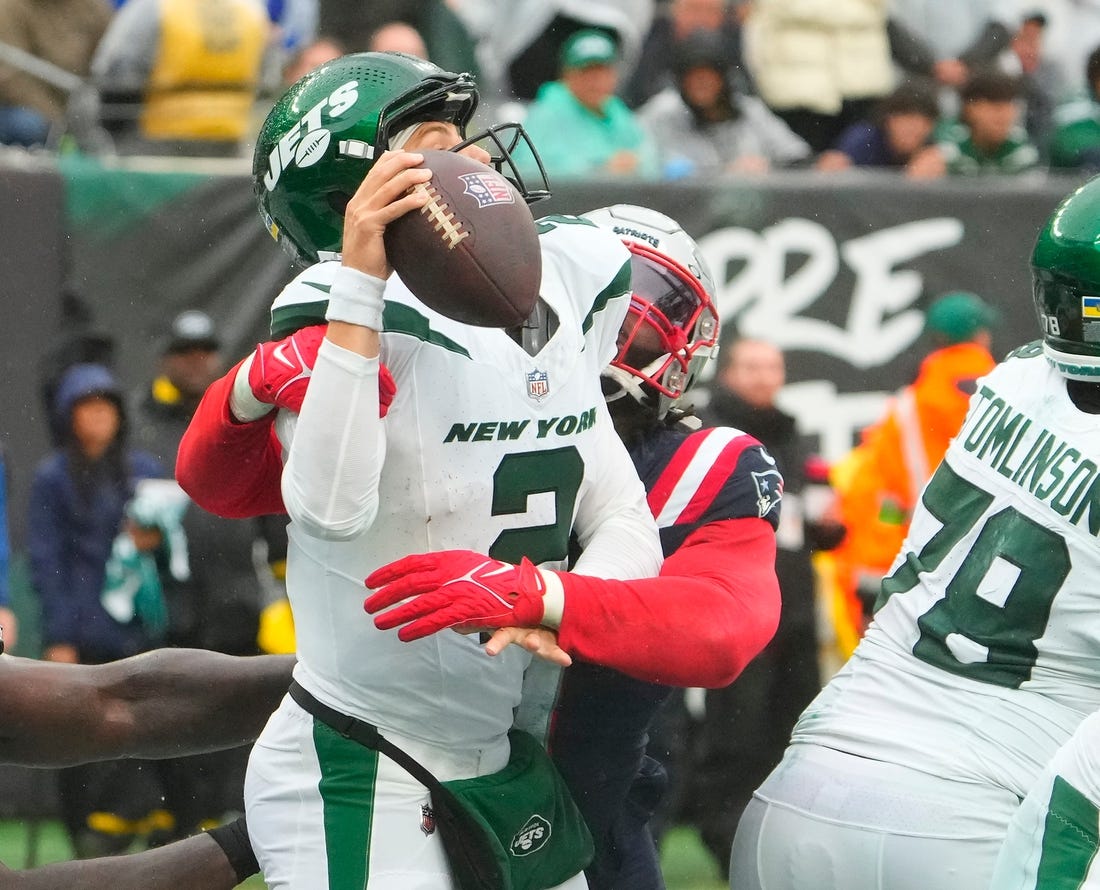 Sep 24, 2023; East Rutherford, New Jersey, USA; New York Jets quarterback Zach Wilson (2) is sacked for a safety by New England Patriots linebacker Matthew Judon (9) in the 4th quarter at MetLife Stadium. Mandatory Credit: Robert Deutsch-USA TODAY Sports