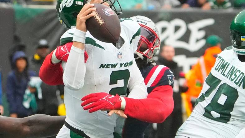 Sep 24, 2023; East Rutherford, New Jersey, USA; New York Jets quarterback Zach Wilson (2) is sacked for a safety by New England Patriots linebacker Matthew Judon (9) in the 4th quarter at MetLife Stadium. Mandatory Credit: Robert Deutsch-USA TODAY Sports