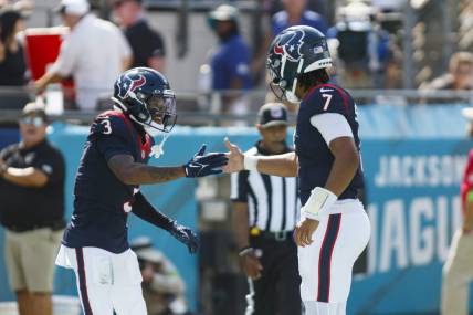 Sep 24, 2023; Jacksonville, Florida, USA; Houston Texans wide receiver Tank Dell (3) and quarterback C.J. Stroud (7) celebrate a touchdown against the Jacksonville Jaguars during the fourth quarter at EverBank Stadium. Mandatory Credit: Morgan Tencza-USA TODAY Sports