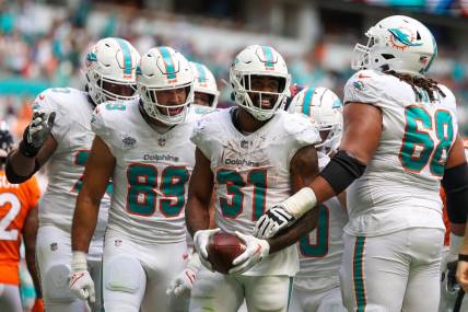 Sep 24, 2023; Miami Gardens, Florida, USA;  Miami Dolphins running back Raheem Mostert (31) celebrates after scoring a touchdown against the Denver Broncos in the third quarter at Hard Rock Stadium. Mandatory Credit: Nathan Ray Seebeck-USA TODAY Sports