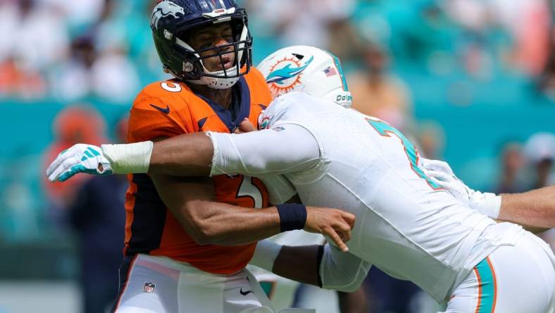 Sep 24, 2023; Miami Gardens, Florida, USA;  Denver Broncos quarterback Russell Wilson (3) is pressured by Miami Dolphins linebacker Bradley Chubb (2) in the second quarter at Hard Rock Stadium. Mandatory Credit: Nathan Ray Seebeck-USA TODAY Sports