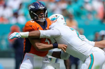 Sep 24, 2023; Miami Gardens, Florida, USA;  Denver Broncos quarterback Russell Wilson (3) is pressured by Miami Dolphins linebacker Bradley Chubb (2) in the second quarter at Hard Rock Stadium. Mandatory Credit: Nathan Ray Seebeck-USA TODAY Sports