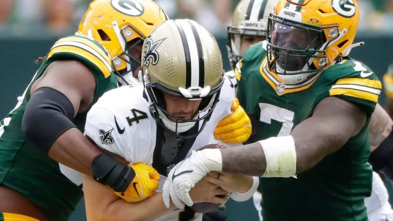 Green Bay Packers linebacker Rashan Gary (52) and linebacker Quay Walker (7) sack New Orleans Saints quarterback Derek Carr (4) during their football game Sunday, September 24, 2023, at Lambeau Field in Green Bay, Wis. The Packers defeated the Saints 18-17.