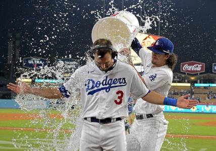 Sep 24, 2023; Los Angeles, California, USA; Los Angeles Dodgers center fielder James Outman (33) dumps a bucket of ice water on shortstop Chris Taylor (3) after he hit a walk-off RBI single to defeat the San Francisco Giants in the tenth inning at Dodger Stadium. Mandatory Credit: Jayne Kamin-Oncea-USA TODAY Sports