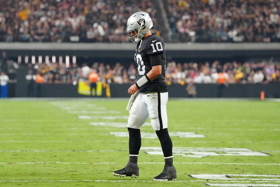 Sep 24, 2023; Paradise, Nevada, USA; Las Vegas Raiders quarterback Jimmy Garoppolo (10) walks back to the huddle after being knocked to the ground by the Pittsburgh Steelers defense during the fourth quarter at Allegiant Stadium. Mandatory Credit: Stephen R. Sylvanie-USA TODAY Sports