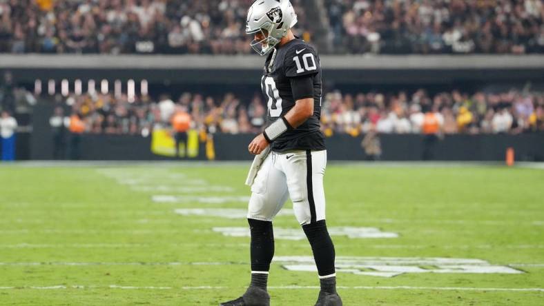 Sep 24, 2023; Paradise, Nevada, USA; Las Vegas Raiders quarterback Jimmy Garoppolo (10) walks back to the huddle after being knocked to the ground by the Pittsburgh Steelers defense during the fourth quarter at Allegiant Stadium. Mandatory Credit: Stephen R. Sylvanie-USA TODAY Sports