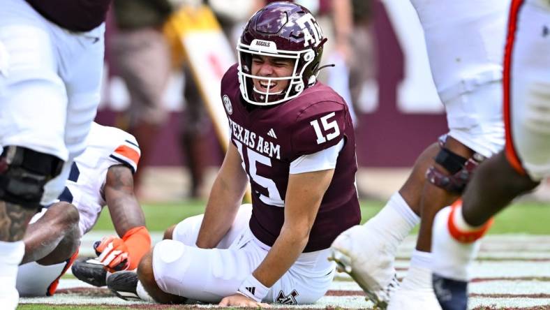 Sep 23, 2023; College Station, Texas, USA; Texas A&M Aggies quarterback Conner Weigman (15) reacts after getting hit during the second quarter against the Auburn Tigers at Kyle Field. Mandatory Credit: Maria Lysaker-USA TODAY Sports