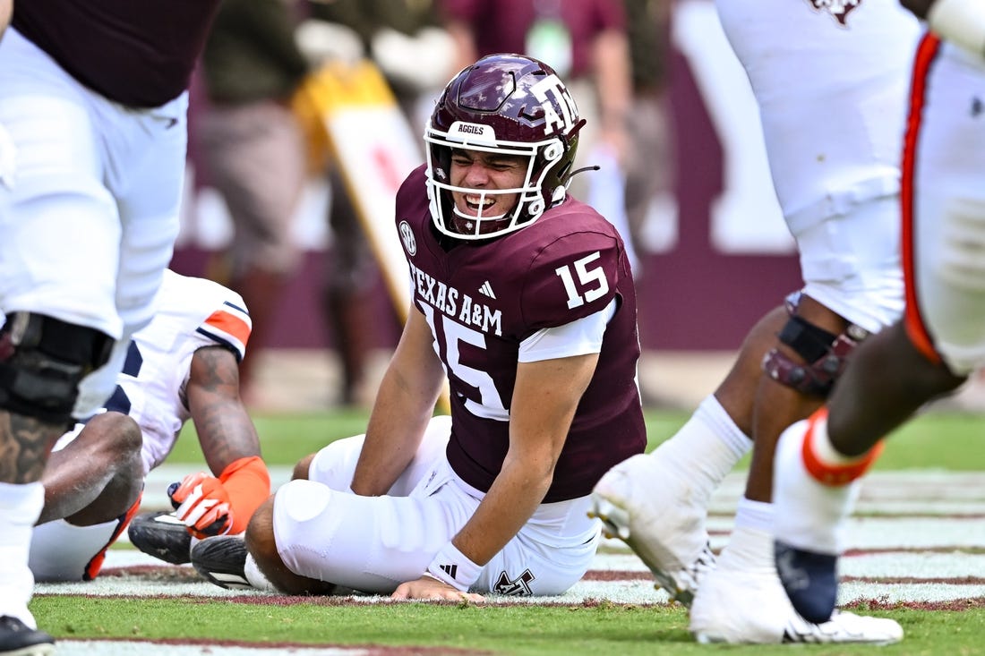 Sep 23, 2023; College Station, Texas, USA; Texas A&M Aggies quarterback Conner Weigman (15) reacts after getting hit during the second quarter against the Auburn Tigers at Kyle Field. Mandatory Credit: Maria Lysaker-USA TODAY Sports