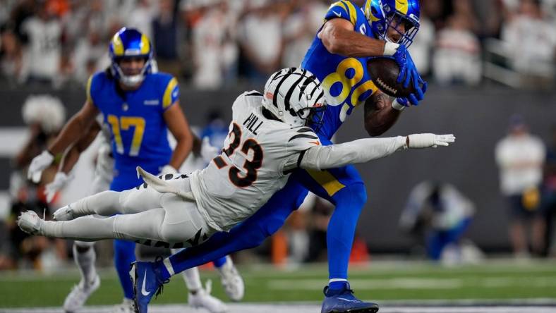 Sep 25, 2023; Cincinnati, Ohio, USA; Los Angeles Rams tight end Tyler Higbee (89) catches a pass over Cincinnati Bengals safety Dax Hill (23) in the second quarter of the NFL Week 3 game between the Cincinnati Bengals and the Los Angeles Rams at Paycor Stadium. Mandatory Credit: Sam Greene-USA TODAY Sports