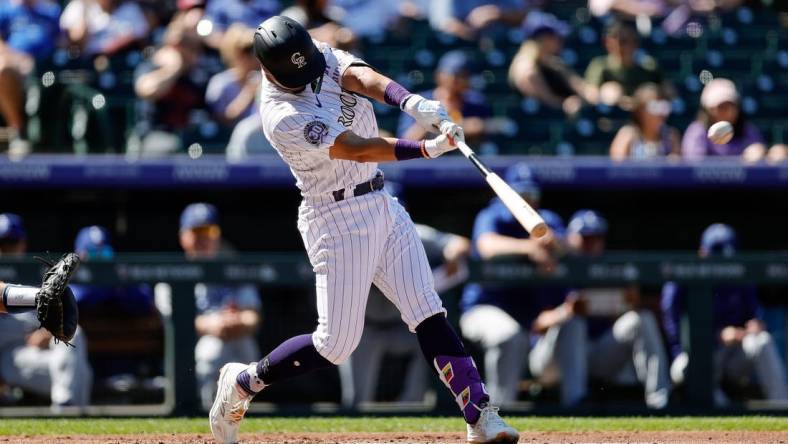 -Sep 26, 2023; Denver, Colorado, USA; Colorado Rockies shortstop Ezequiel Tovar (14) hits a double in the second inning against the Los Angeles Dodgers at Coors Field. Mandatory Credit: Isaiah J. Downing-USA TODAY Sports