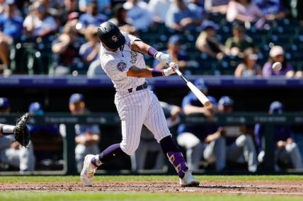-Sep 26, 2023; Denver, Colorado, USA; Colorado Rockies shortstop Ezequiel Tovar (14) hits a double in the second inning against the Los Angeles Dodgers at Coors Field. Mandatory Credit: Isaiah J. Downing-USA TODAY Sports