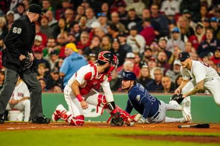 Sep 26, 2023; Boston, Massachusetts, USA; Tampa Bay Rays right fielder Josh Lowe (15) safe at home plate against Boston Red Sox catcher Reese McGuire (3) in the third inning at Fenway Park. Mandatory Credit: David Butler II-USA TODAY Sports