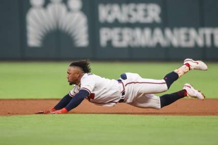 Sep 26, 2023; Atlanta, Georgia, USA; Atlanta Braves second baseman Ozzie Albies (1) slide into second with a double against the Chicago Cubs in the first inning at Truist Park. Mandatory Credit: Brett Davis-USA TODAY Sports
