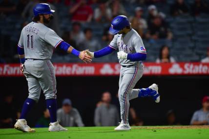 Sep 26, 2023; Anaheim, California, USA; Texas Rangers shortstop Josh Smith (47) is greeted by catcher Austin Hedges (11) after hitting a two run home run against the Los Angeles Angels during the ninth inning at Angel Stadium. Mandatory Credit: Gary A. Vasquez-USA TODAY Sports