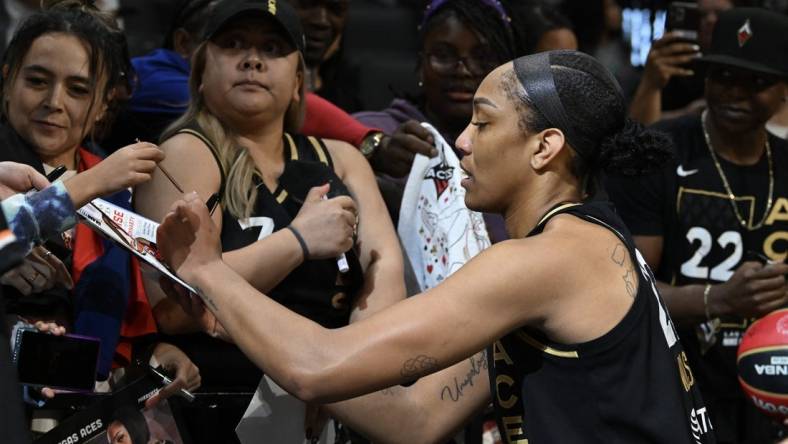 Sep 26, 2023; Las Vegas, Nevada, USA; Las Vegas Aces forward A'ja Wilson (22) signs autographs after defeating the Dallas Wings in game two of the 2023 WNBA Playoffs at Michelob Ultra Arena. Mandatory Credit: Candice Ward-USA TODAY Sports