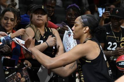 Sep 26, 2023; Las Vegas, Nevada, USA; Las Vegas Aces forward A'ja Wilson (22) signs autographs after defeating the Dallas Wings in game two of the 2023 WNBA Playoffs at Michelob Ultra Arena. Mandatory Credit: Candice Ward-USA TODAY Sports
