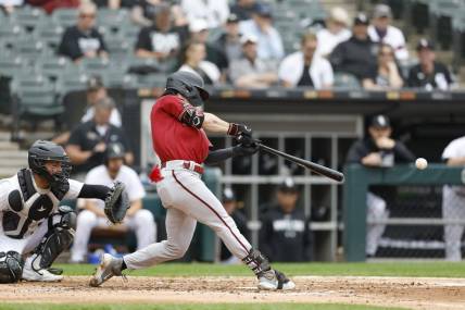 Sep 27, 2023; Chicago, Illinois, USA; Arizona Diamondbacks left fielder Corbin Carroll (7) hits a two-run double against the Chicago White Sox during the third inning at Guaranteed Rate Field. Mandatory Credit: Kamil Krzaczynski-USA TODAY Sports