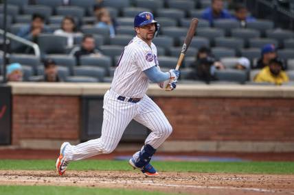 Sep 27, 2023; New York City, New York, USA; New York Mets first baseman Pete Alonso (20) doubles during the sixth inning against the Miami Marlins at Citi Field. Mandatory Credit: Vincent Carchietta-USA TODAY Sports