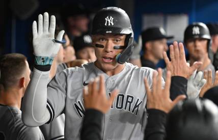 Sep 27, 2023; Toronto, Ontario, CAN;  New York Yankees right fielder Aaron Judge (99) celebrates in the dugout with team mates after hitting a two run home run against the Toronto Blue Jays in the fourth inning at Rogers Centre. Mandatory Credit: Dan Hamilton-USA TODAY Sports