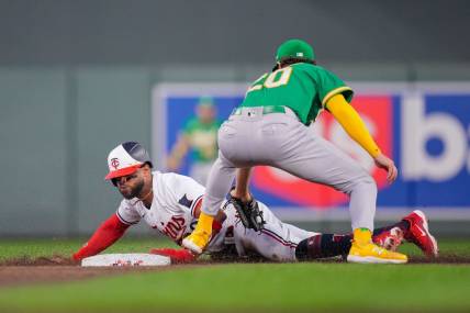 Sep 27, 2023; Minneapolis, Minnesota, USA; Minnesota Twins center fielder Willi Castro (50) steals second base against the Oakland Athletics second baseman Zack Gelof (20) in the second inning at Target Field. Mandatory Credit: Brad Rempel-USA TODAY Sports