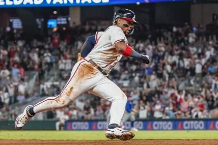 Sep 27, 2023; Cumberland, Georgia, USA; Atlanta Braves right fielder Ronald Acuna Jr. (13) rounds third base on his way to scoring a run against the Chicago Cubs during the eighth inning at Truist Park. Mandatory Credit: Dale Zanine-USA TODAY Sports