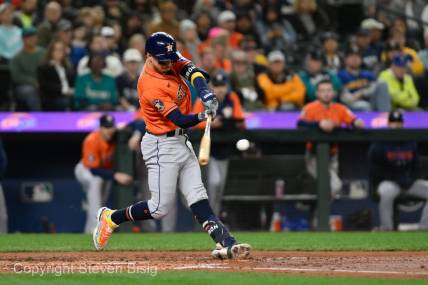 Sep 27, 2023; Seattle, Washington, USA; Houston Astros center fielder Mauricio Dubon (14) hits a 3-run home run against the Seattle Mariners during the fourth inning at T-Mobile Park. Mandatory Credit: Steven Bisig-USA TODAY Sports