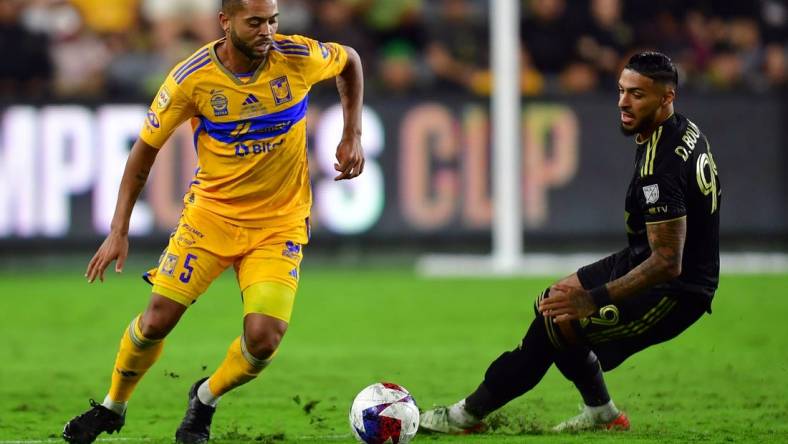 Sep 27, 2023; Los Angeles, CA, USA; Los Angeles FC forward Denis Bouanga (99) and Tigres UANL midfielder Rafael Carioca (5) battle for the ball in the second half at BMO Stadium. Mandatory Credit: Gary A. Vasquez-USA TODAY Sports