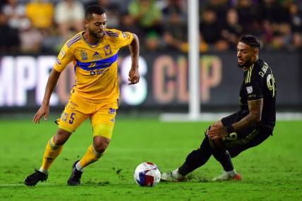 Sep 27, 2023; Los Angeles, CA, USA; Los Angeles FC forward Denis Bouanga (99) and Tigres UANL midfielder Rafael Carioca (5) battle for the ball in the second half at BMO Stadium. Mandatory Credit: Gary A. Vasquez-USA TODAY Sports