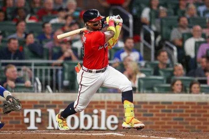 Matt Olson of the Atlanta Braves hits a RBI single in the first