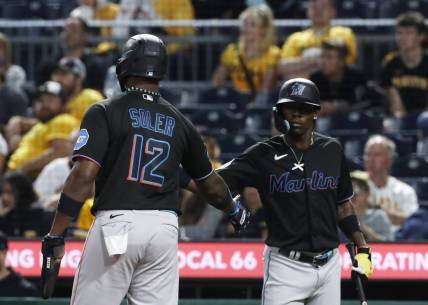 Sep 29, 2023; Pittsburgh, Pennsylvania, USA;  Miami Marlins center fielder Jazz Chisholm Jr. (right) congratulates designated hitter Jorge Soler (12) after Soler  scored a run against the Pittsburgh Pirates during the eighth inning at PNC Park. Mandatory Credit: Charles LeClaire-USA TODAY Sports