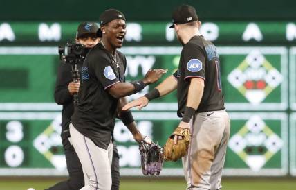 Sep 29, 2023; Pittsburgh, Pennsylvania, USA;  Miami Marlins center fielder Jazz Chisholm Jr. (2) and shortstop  Garrett Hampson (1) celebrate after defeating the Pittsburgh Pirates at PNC Park. Miami won 4-3. Mandatory Credit: Charles LeClaire-USA TODAY Sports