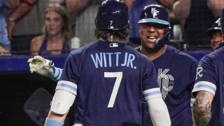 Sep 29, 2023; Kansas City, Missouri, USA; Kansas City Royals shortstop Bobby Witt Jr. (7) celebrates with first baseman Salvador Perez (13) after hitting his 30th home run of his career, a two run home run against the New York Yankees in the seventh inning at Kauffman Stadium. Mandatory Credit: Denny Medley-USA TODAY Sports