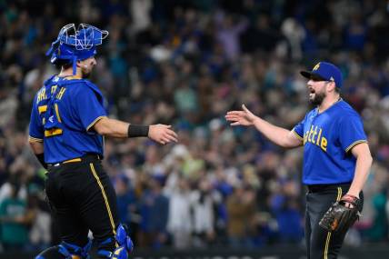 Sep 29, 2023; Seattle, Washington, USA; Seattle Mariners catcher Cal Raleigh (29) and relief pitcher Dominic Leone (54) celebrate defeating the Texas Rangers at T-Mobile Park. Mandatory Credit: Steven Bisig-USA TODAY Sports