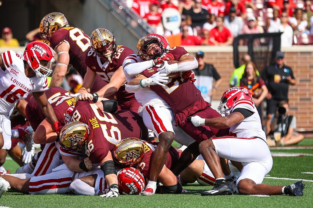 Sep 30, 2023; Minneapolis, Minnesota, USA; Minnesota Golden Gophers running back Bryce Williams (21) is tackled against the Louisiana-Lafayette Ragin Cajuns defense during the second quarter at Huntington Bank Stadium. Mandatory Credit: Matt Krohn-USA TODAY Sports