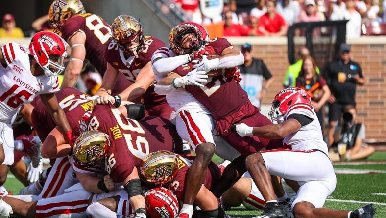 Sep 30, 2023; Minneapolis, Minnesota, USA; Minnesota Golden Gophers running back Bryce Williams (21) is tackled against the Louisiana-Lafayette Ragin Cajuns defense during the second quarter at Huntington Bank Stadium. Mandatory Credit: Matt Krohn-USA TODAY Sports