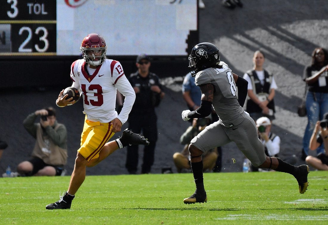 Sep 30, 2023; Boulder, Colorado, USA; USC Trojans quarterback Caleb Williams (13) scrambles for a few yards as he gets chased by Colorado Buffaloes safety Jahquez Robinson (8) during the first quarter at Folsom Field. Mandatory Credit: John Leyba-USA TODAY Sports