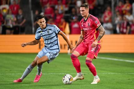 Sep 30, 2023; St. Louis, Missouri, USA; Sporting Kansas City forward D  niel Sall  i (20) and St. Louis City defender Jake Nerwinski (2) battle for the ball during the first half at CITYPARK. Mandatory Credit: Joe Puetz-USA TODAY Sports