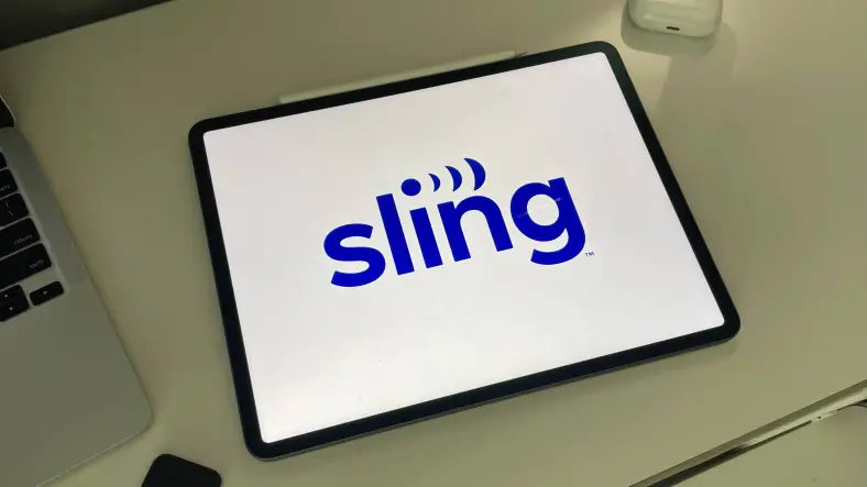 iPad on a desk displaying the Sling TV logo