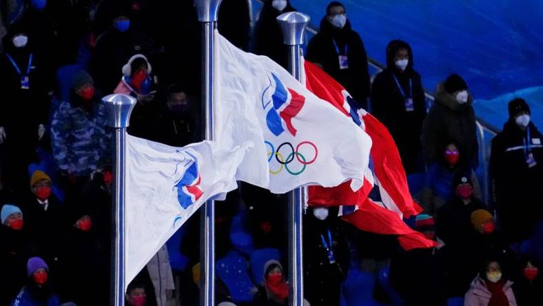 Feb 20, 2022; Beijing, CHINA; Two Russian Olympic Committee flags and the flag of Norway are displayed during the medal ceremony for the cross-country skiing men's 50km mass start during the closing ceremony for the Beijing 2022 Olympic Winter Games at Beijing National Stadium. Mandatory Credit: George Walker IV-USA TODAY Sports