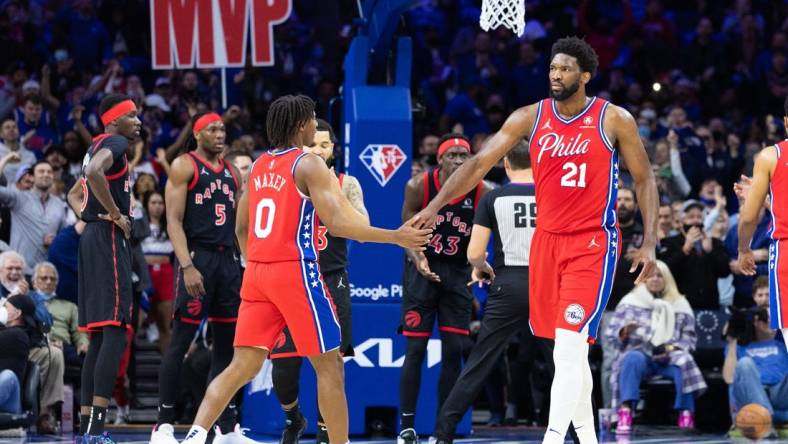 Apr 18, 2022; Philadelphia, Pennsylvania, USA; Philadelphia 76ers center Joel Embiid (21) reacts with guard Tyrese Maxey (0) after a score and one against the Toronto Raptors during the first quarter in game two of the first round for the 2022 NBA playoffs at Wells Fargo Center. Mandatory Credit: Bill Streicher-USA TODAY Sports