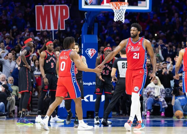 Apr 18, 2022; Philadelphia, Pennsylvania, USA; Philadelphia 76ers center Joel Embiid (21) reacts with guard Tyrese Maxey (0) after a score and one against the Toronto Raptors during the first quarter in game two of the first round for the 2022 NBA playoffs at Wells Fargo Center. Mandatory Credit: Bill Streicher-USA TODAY Sports