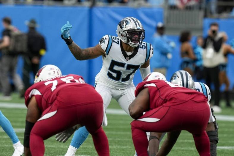 Oct 2, 2022; Charlotte, North Carolina, USA; Carolina Panthers linebacker Damien Wilson (57) motions to his teammates against the Arizona Cardinals during the second quarter at Bank of America Stadium. Mandatory Credit: Jim Dedmon-USA TODAY Sports