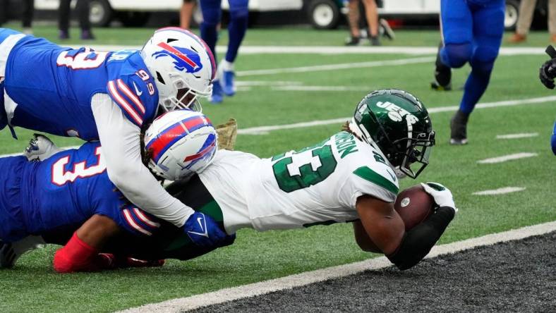 Nov 6, 2022; East Rutherford, NJ, USA; 
New York Jets running back James Robinson (23) scores a 4th quarter touchdown against the Bills at MetLife Stadium. Mandatory Credit: Robert Deutsch-USA TODAY Sports