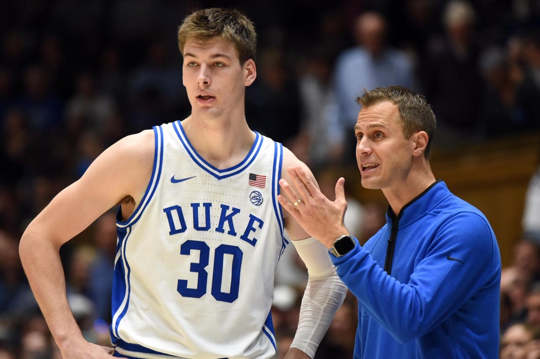 Nov 30, 2022; Durham, North Carolina, USA; Duke Blue Devils head coach Jon Scheyer (right) gives instructions to  center Kyle Filipowski(30)  during the second half against the Ohio State Buckeyes at Cameron Indoor Stadium.  The Blue Devils won 81-72. Mandatory Credit: Rob Kinnan-USA TODAY Sports