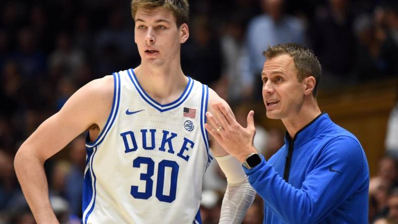 Nov 30, 2022; Durham, North Carolina, USA; Duke Blue Devils head coach Jon Scheyer (right) gives instructions to  center Kyle Filipowski(30)  during the second half against the Ohio State Buckeyes at Cameron Indoor Stadium.  The Blue Devils won 81-72. Mandatory Credit: Rob Kinnan-USA TODAY Sports