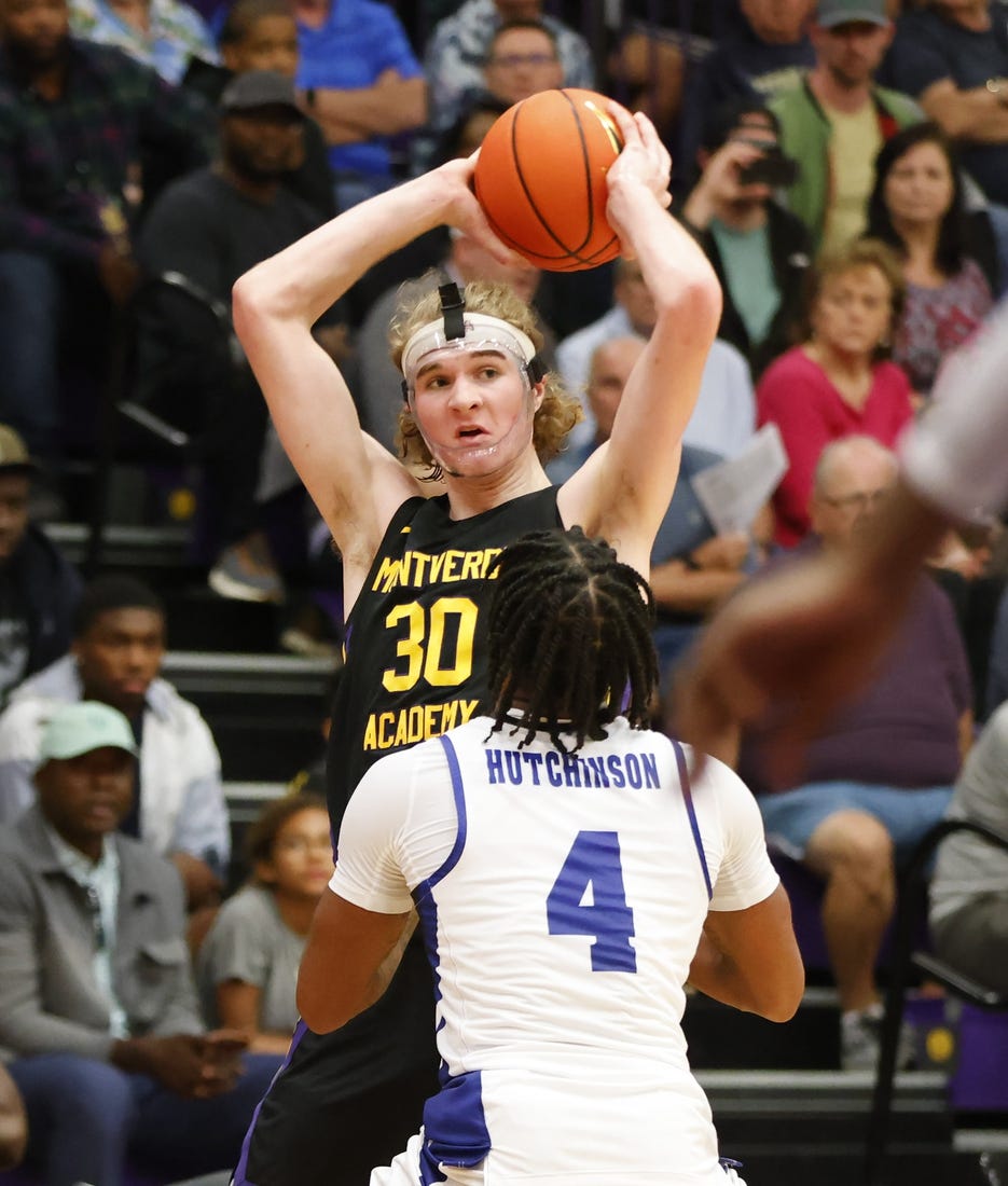 Dec 1, 2022; Montverde, Florida, USA; Montverde Academy guard Liam McNeeley (30) looks to pass the ball over IMG Academy guard Jacoi Hutchinson (4) during the second half of the Sunshine Classic basketball tournament at Mills Championship Court on the campus of Montverde Academy. Mandatory Credit: Reinhold Matay-USA TODAY Sports