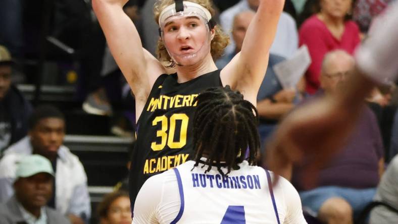 Dec 1, 2022; Montverde, Florida, USA; Montverde Academy guard Liam McNeeley (30) looks to pass the ball over IMG Academy guard Jacoi Hutchinson (4) during the second half of the Sunshine Classic basketball tournament at Mills Championship Court on the campus of Montverde Academy. Mandatory Credit: Reinhold Matay-USA TODAY Sports