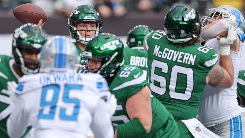 Dec 18, 2022; East Rutherford, New Jersey, USA; New York Jets quarterback Zach Wilson (2) throws the ball  as center Connor McGovern (60) blocks during the first quarter against the Detroit Lions at MetLife Stadium. Mandatory Credit: Vincent Carchietta-USA TODAY Sports